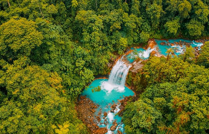 Stunning,Aerial,Perspective,Of,A,Vibrant,Turquoise,Waterfall,Cascading,Through